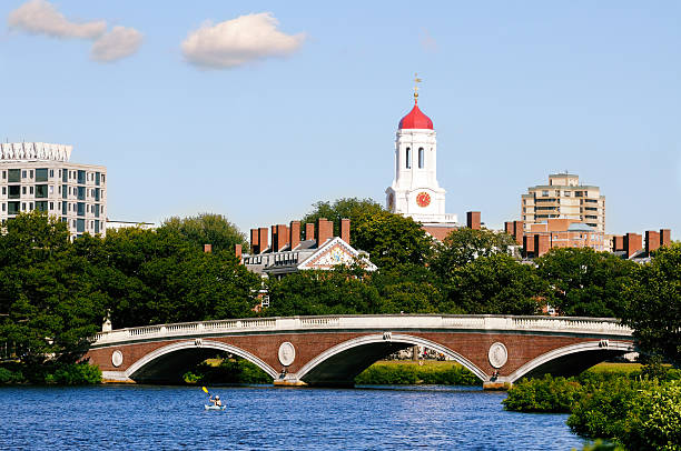 Harvard University View of Harvard University and pedestrian bridge on Charles River in Cambridge, Massachusetts cambridge massachusetts stock pictures, royalty-free photos & images