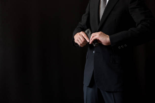 istock Man in a suits and holding old semi-automatic pistol 1315421289