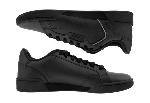 istock Sneakers isolated on white background. Black sneakers close-up on a white background. 1315422134