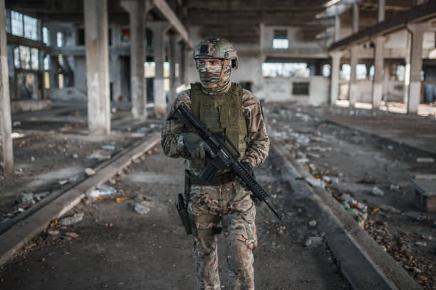 istock Armed soldier in camouflage uniform on patrol in war zone 1315427163