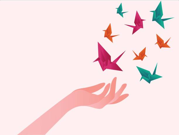 Hands freeing the colorful bird shaped origamis Origami birds vector concept with hands freeing the colorful bird shaped origamis in white background origami hand stock illustrations