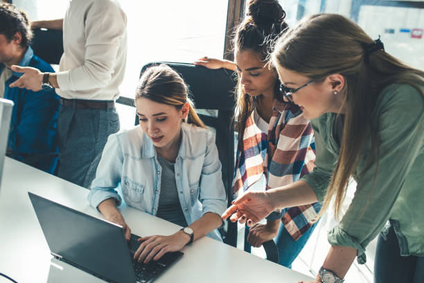 istock Group of team workers and programmers starting a new project.Senior programmer giving help to beginner. 1315432712