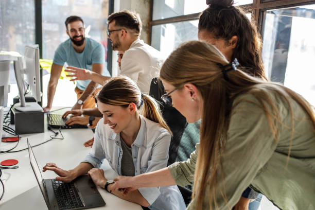istock Group of team workers and programmers starting a new project.Senior programmer giving help to beginner. 1315432727
