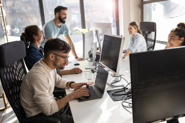 istock Young male programmer sitting at the desk in his office and working . 1315432760