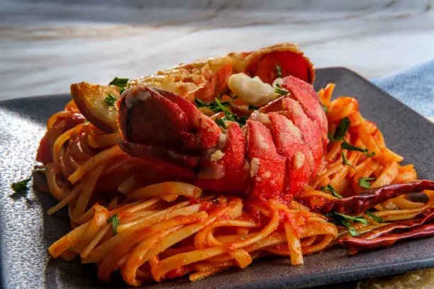 Pan fried sliced Italian lobster tail fra diavolo linguine