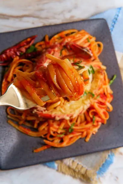 Pan fried sliced Italian lobster tail fra diavolo linguine