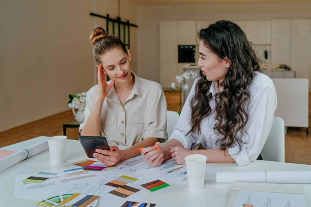 istock Two women designers discussing new clothes models 1315443091
