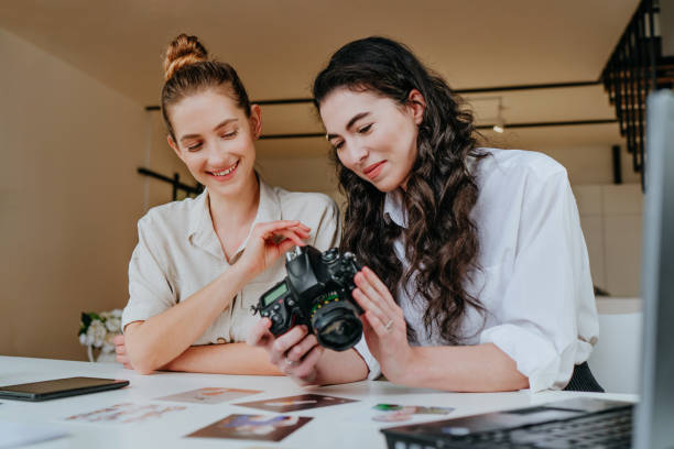 istock Two young women selecting photos on the camera indoor 1315443850