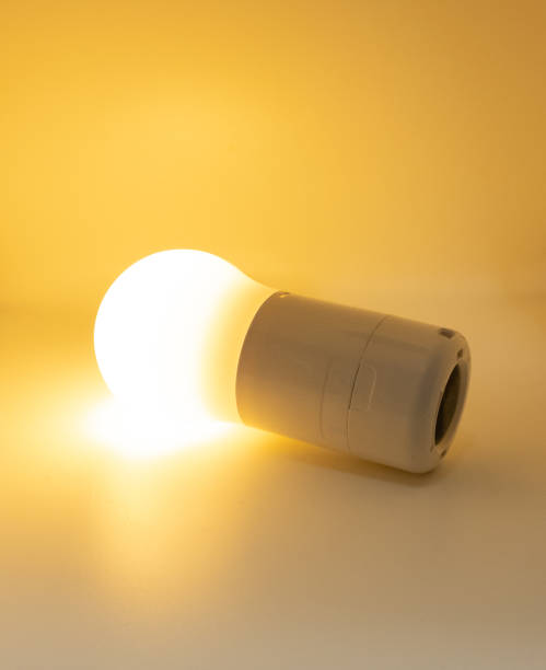 istock illuminated warm light electric light bulb opened on yellow background 1315444052