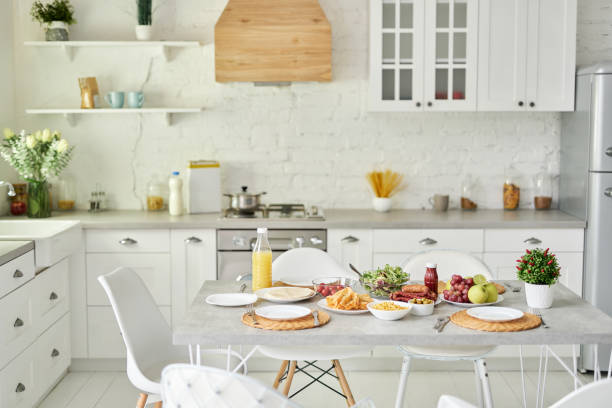 istock Latin style breakfast on the table. Modern bright white kitchen interior with wooden and white details 1315445810