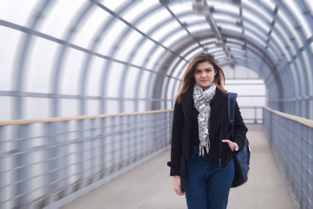 istock young woman walks quickly through the covered walkway 1315446821