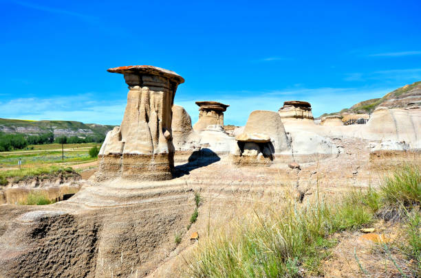 Hoodoo rock formations under blue skies, Drumheller, Alberta, Canada Scenic hoodoo rock formations under blue skies near Drumheller, Alberta, Canada drumheller stock pictures, royalty-free photos & images