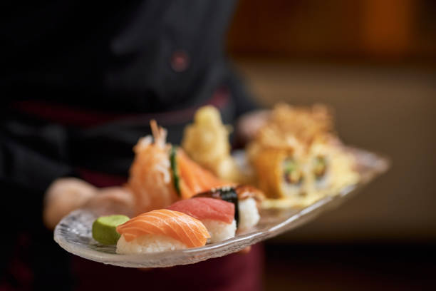 istock Freshly-made sushi set being delivered to restaurant table 1315450127