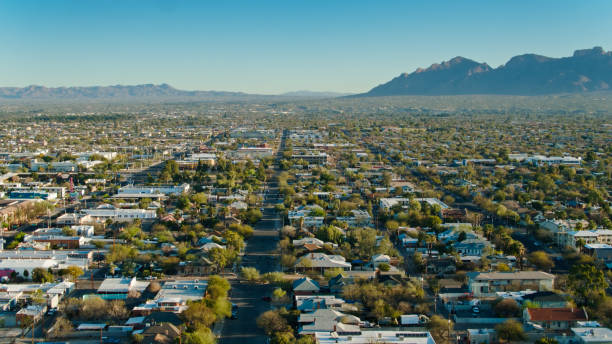 Aerial View of Urban Sprawl Spilling Out of Tucson, Arizona Residential and commercial properties stretch to the mountains beyond Tucson, Arizona. tucson stock pictures, royalty-free photos & images
