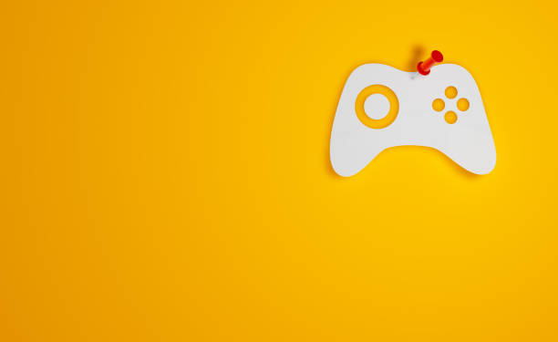 istock Pin Paper Video game controller Symbol on Yellow Background 1315451814