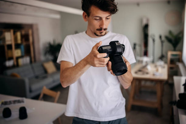 istock Man checking pictures on camera at home 1315452208