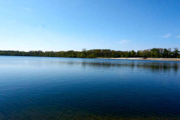 istock blue water quarry pond lake under blue sky and sunshine 1315453435