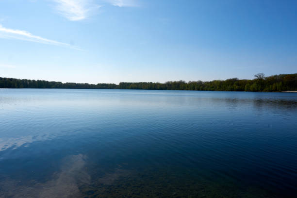 istock blue water quarry pond lake under blue sky and sunshine 1315453443