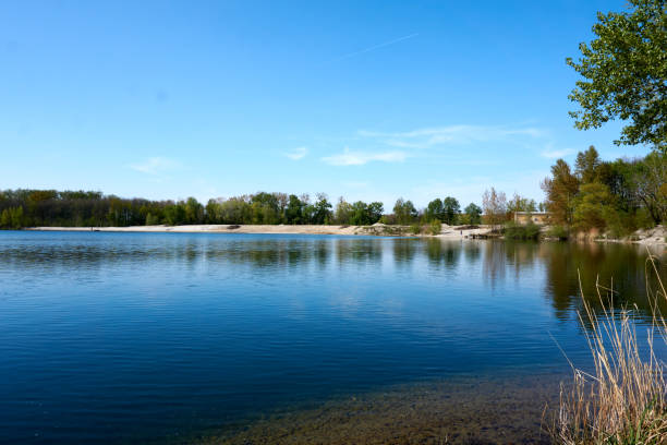 istock blue water quarry pond lake under blue sky and sunshine 1315453457