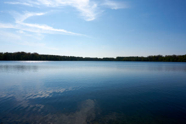 istock blue water quarry pond lake under blue sky and sunshine 1315453463
