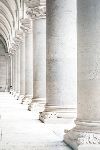 Row of white marble columns. Vertical image