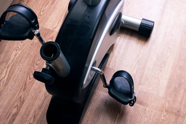 exercise bike pedals on wood floor background - pedal imagens e fotografias de stock