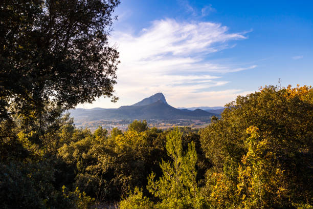 View of the Pic Saint-Loup through the vegetation from the garrigue (Occitanie, France) stock photo