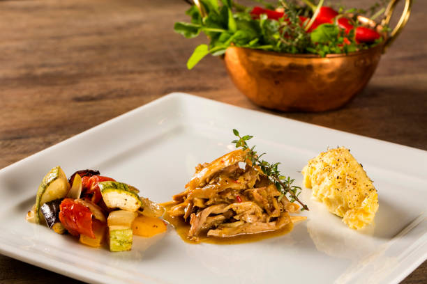 istock shredded chicken with mashed potatoes and vegetables served in the table. 1315458585
