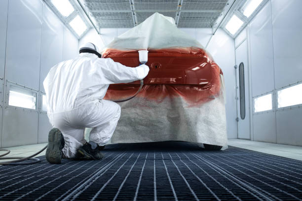 istock Professional painter painting vehicle in the workshop. 1315463041