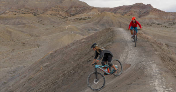 istock Mountain bikers descend mountain ridge in the morning 1315463311
