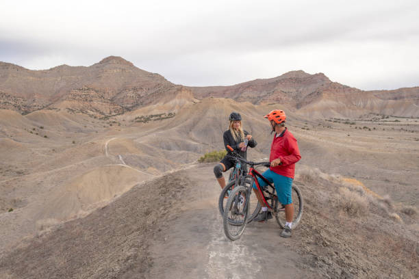 istock Mountain bikers relax on mountain ridge in the morning 1315463371