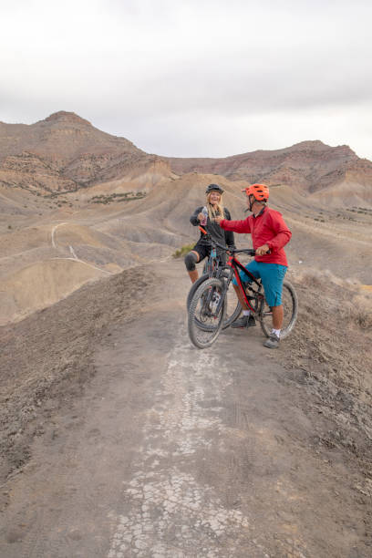 istock Mountain bikers relax on mountain ridge in the morning 1315463375