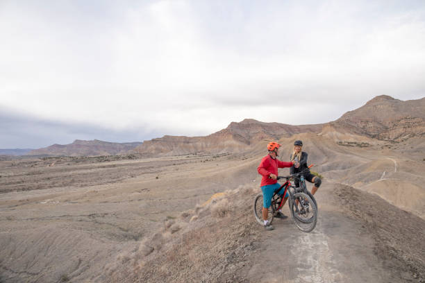 Mountain bikers relax on mountain ridge in the morning