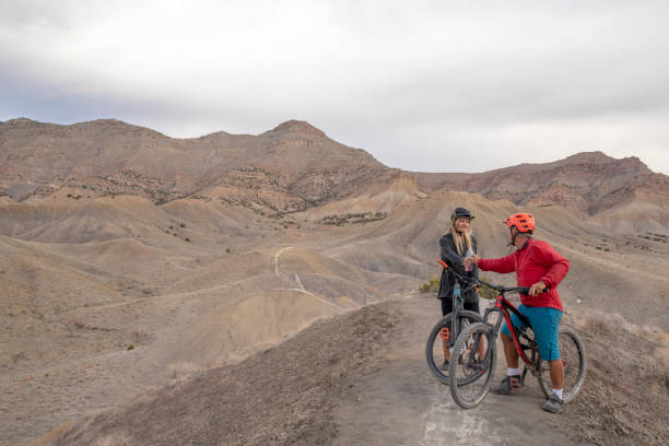 istock Mountain bikers relax on mountain ridge in the morning 1315463438