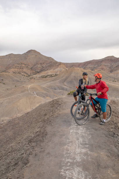 istock Mountain bikers relax on mountain ridge in the morning 1315463444