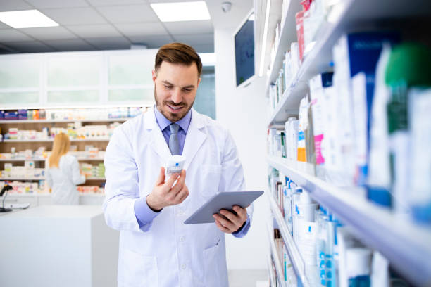 istock Pharmacist working in drug store and checking medicine expiration date on tablet computer. 1315463450