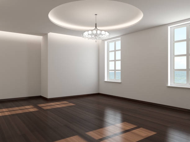istock Empty Interior Lit by the Sun with Two Windows, Chandelier, White Plastered Walls, Cornice Lighting and Dark Parquet Floor with Plinths. 3D Illustration, 7680x5760 1315467452