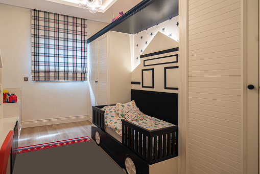 Children's bedroom with black car beds
