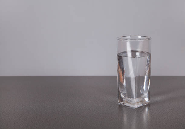 istock Water with glass, on gray background. 1315469104
