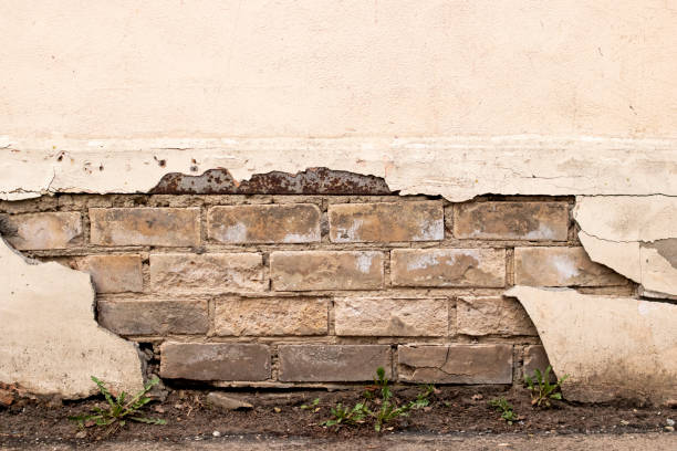 istock Peeling paint on an old brick wall 1315478591