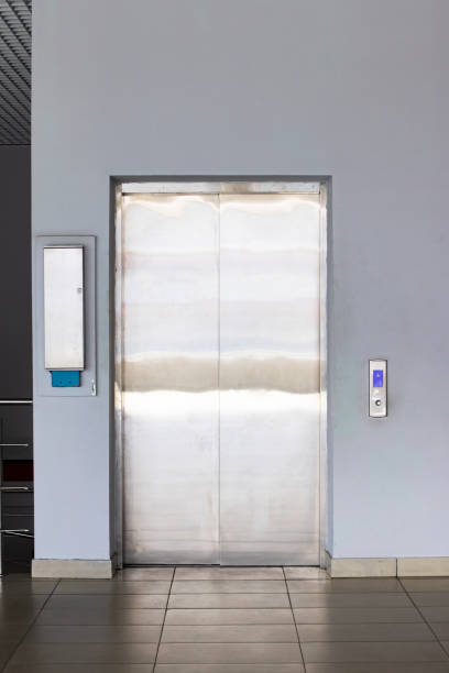 istock Metal elevator door by the stairs closeup 1315479504