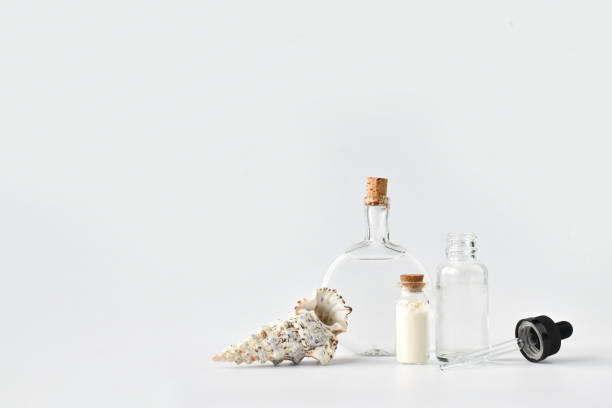 istock Glass bottles on a light background. Bubbles for cosmetics and perfumes. Empty space for text 1315481905
