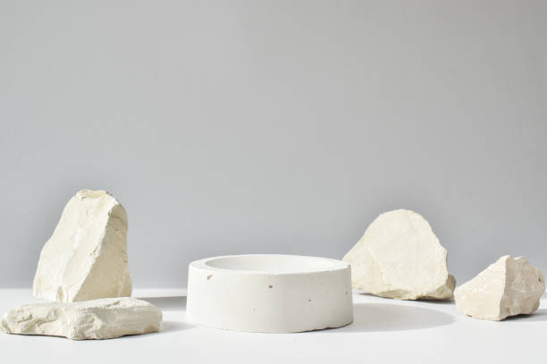 istock One white podium with a geometric concrete figure and stones. A scene with a cement display case. Minimalistic background. Presentation of cosmetics. 1315482837
