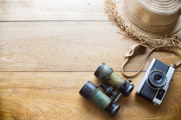 istock Tourism concept ,hat , binocular and old camera on wood 1315483770