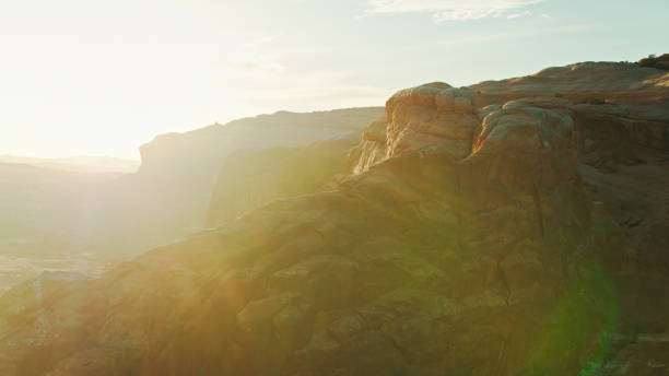 istock Utah Rock Formations Creating Dramatic Lens Flare at Sunset - Aerial 1315485883