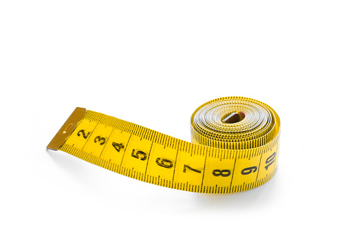 Measuring tape or centimeter isolated on white, close-up.