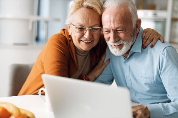 istock Happy senior couple using laptop together at home 1315488439