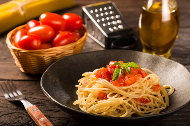 istock Dish with spaghetti in tomato sauce and basil. 1315499383