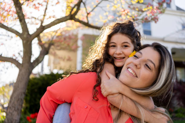 istock Young daughter hugging her mother outdoors during springtime 1315511948