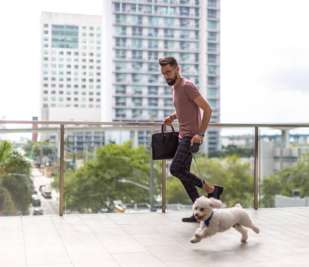 istock Latin man running in the city with small dog 1315512051